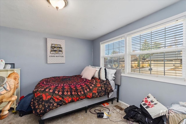 carpeted bedroom with baseboards