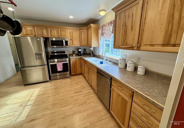 1223 Forest Rd, Winchester, ID 83555 - kitchen featuring stainless steel appliances, a sink, light wood-style floors, recessed lighting, and brown cabinetry