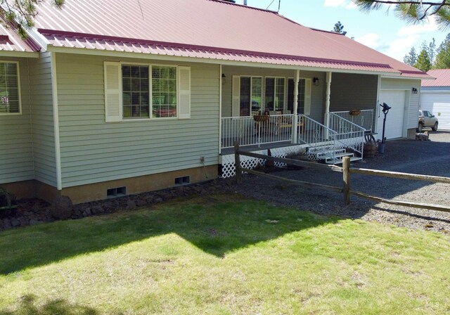 1223 Forest Rd, Winchester, ID 83555 - view of front of house featuring a porch, metal roof, a garage, a front lawn, and driveway