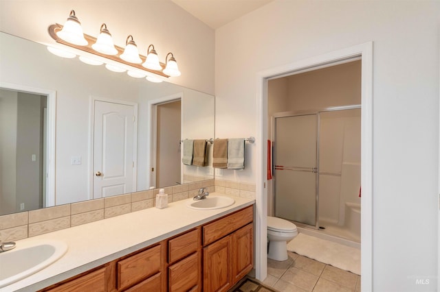 bathroom with toilet, vanity, tile patterned floors, and walk in shower