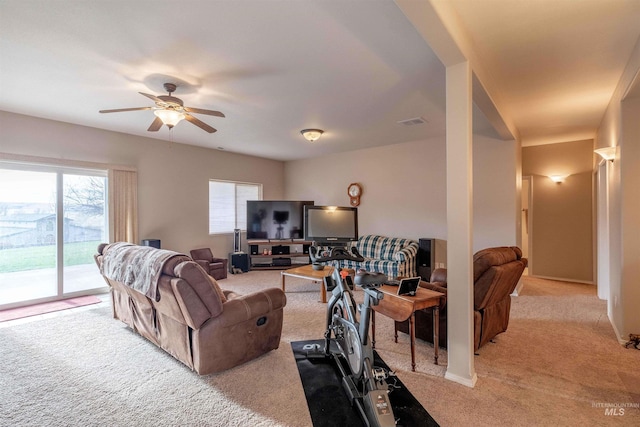 living room with light carpet and ceiling fan