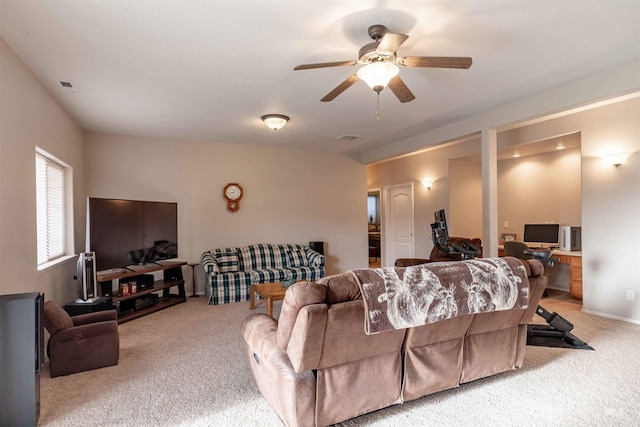 carpeted living room with ceiling fan