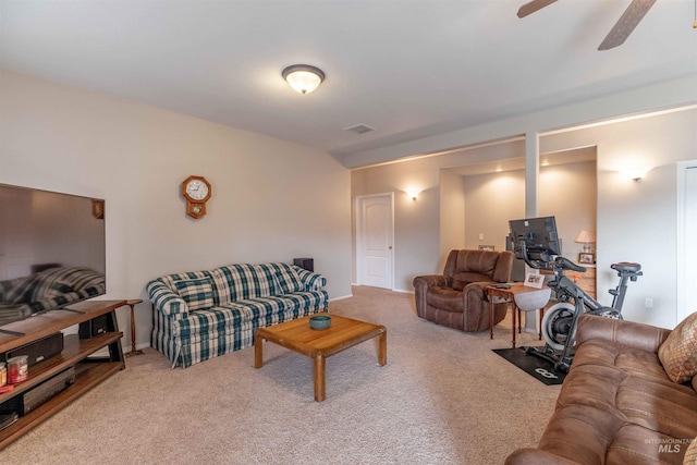 carpeted living room with ceiling fan