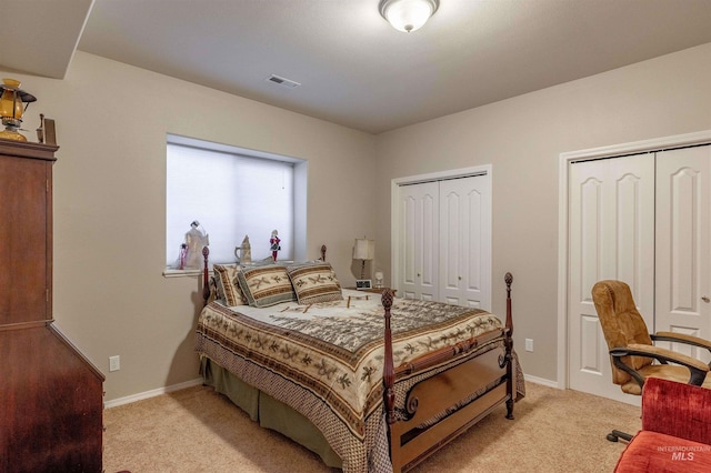 carpeted bedroom with multiple closets