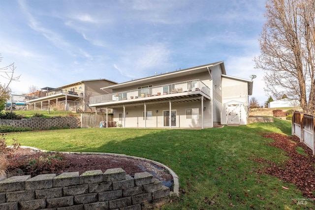 rear view of property featuring a wooden deck and a yard