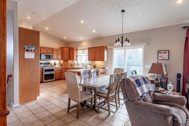 dining area featuring light tile patterned floors, sink, lofted ceiling, and a notable chandelier