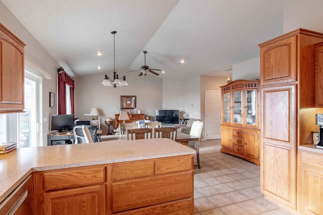 kitchen with light tile patterned floors, ceiling fan with notable chandelier, vaulted ceiling, and hanging light fixtures