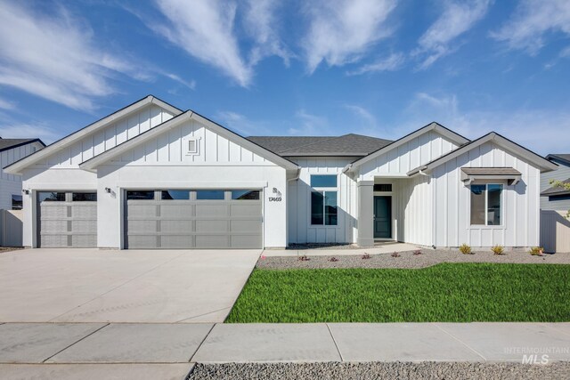 craftsman inspired home with a garage and a front yard