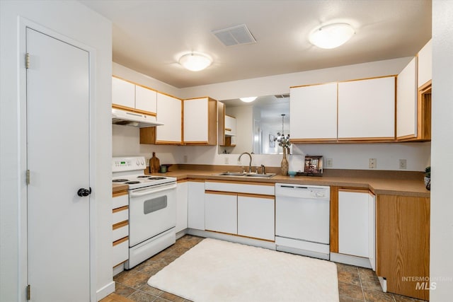 kitchen featuring visible vents, under cabinet range hood, white appliances, white cabinetry, and a sink