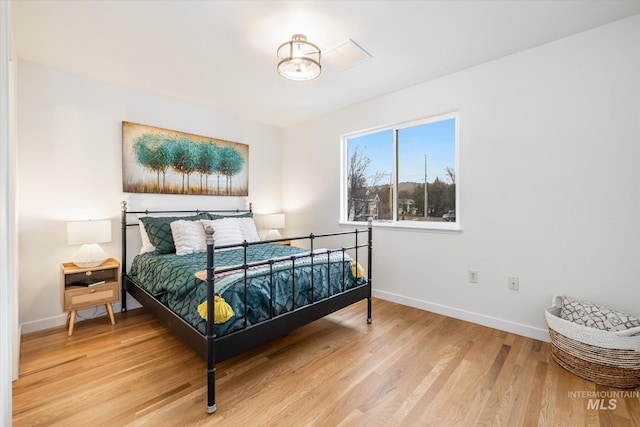 bedroom featuring baseboards and light wood-style floors