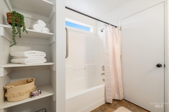 bathroom with tile patterned flooring and shower / bathtub combination with curtain