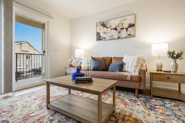 living room with baseboards and light wood-type flooring