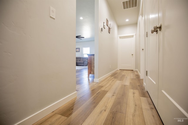 hallway with light hardwood / wood-style floors