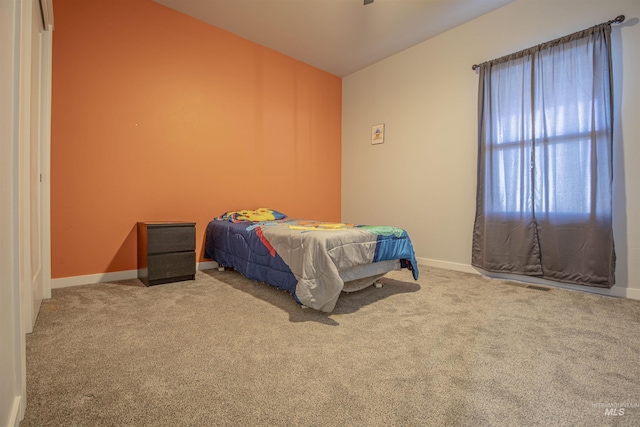 bedroom with lofted ceiling and carpet floors