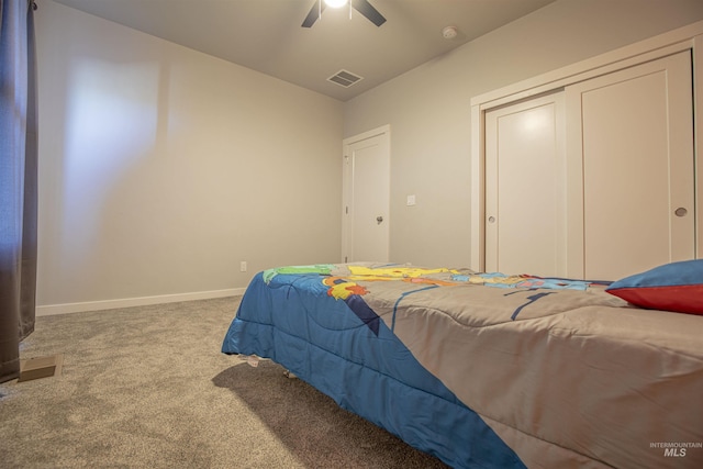 carpeted bedroom with vaulted ceiling, a closet, and ceiling fan