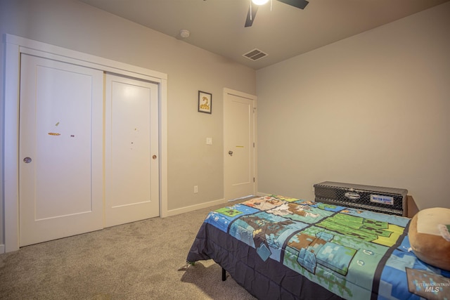 carpeted bedroom featuring ceiling fan and a closet