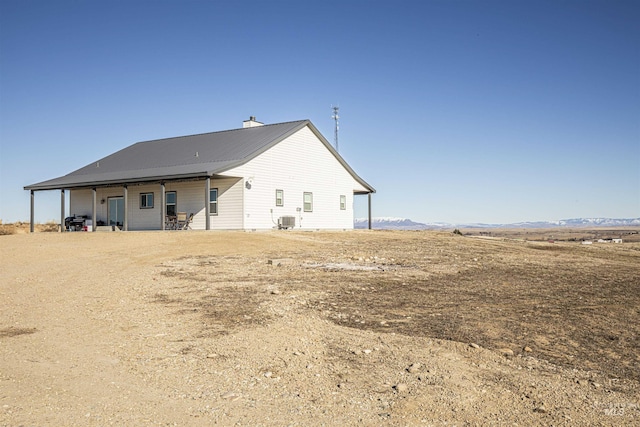 rear view of house with cooling unit