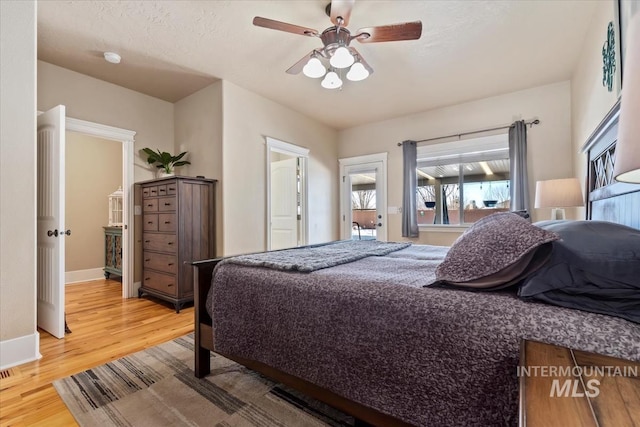 bedroom featuring a textured ceiling, wood-type flooring, and ceiling fan