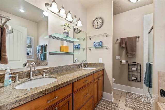 bathroom featuring vanity, tile patterned floors, and toilet