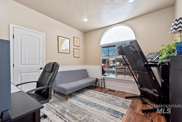 office space featuring wood-type flooring and a textured ceiling