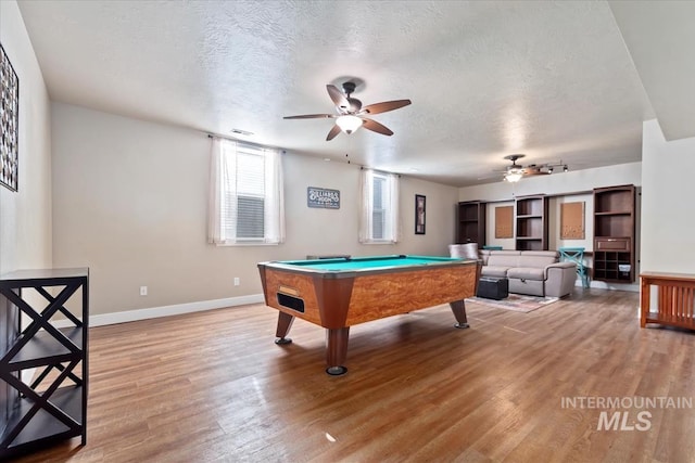 rec room with pool table, ceiling fan, hardwood / wood-style floors, and a textured ceiling