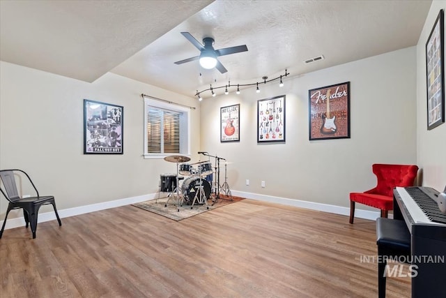 interior space featuring hardwood / wood-style floors, a textured ceiling, and ceiling fan