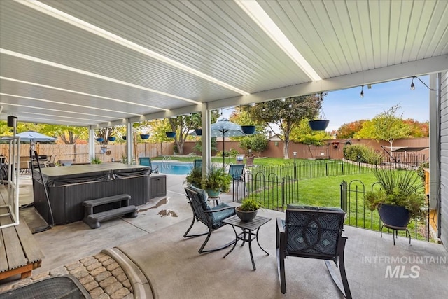 view of patio / terrace featuring a pool with hot tub