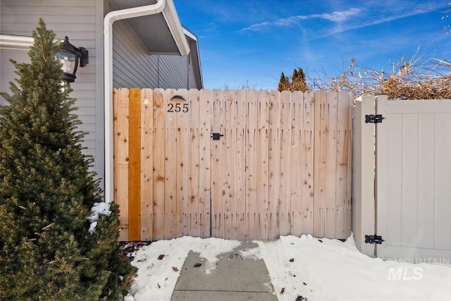 view of snow covered gate