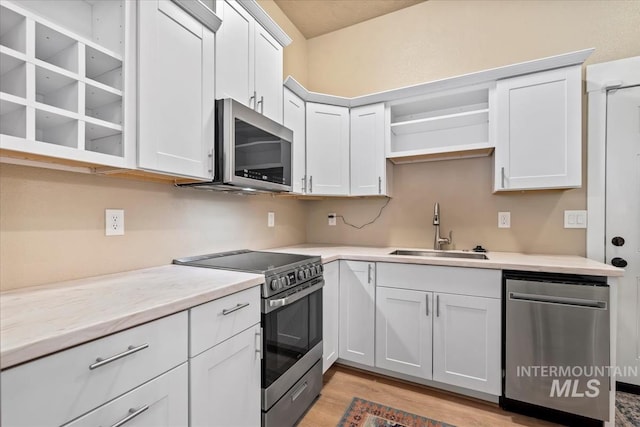 kitchen featuring white cabinetry and appliances with stainless steel finishes