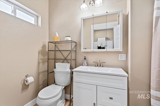 bathroom featuring vanity and toilet