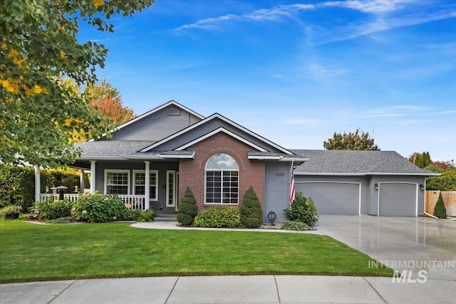 single story home with a garage, a front yard, and covered porch