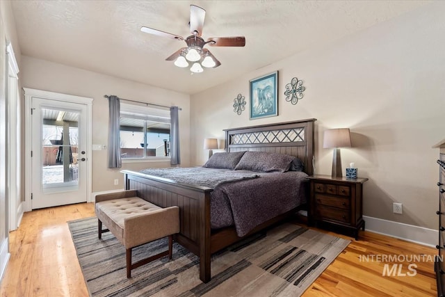 bedroom with ceiling fan, access to exterior, and light wood-type flooring