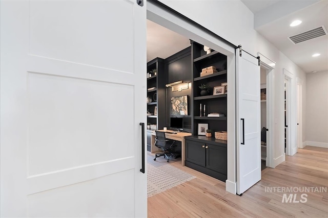 2685 N Fruniz Ave, Eagle, ID 83616 - office area featuring a barn door, light wood-type flooring, built in study area, and recessed lighting