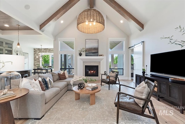 2685 N Fruniz Ave, Eagle, ID 83616 - living area featuring high vaulted ceiling, beam ceiling, wood finished floors, recessed lighting, and a glass covered fireplace