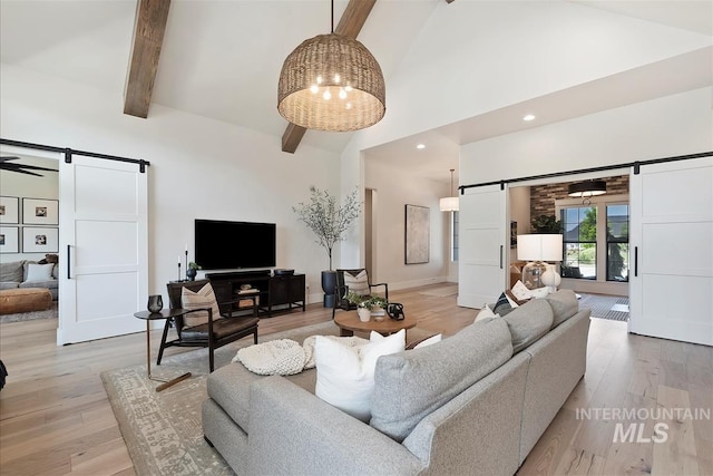 2685 N Fruniz Ave, Eagle, ID 83616 - living area featuring a barn door, high vaulted ceiling, beamed ceiling, and light wood-type flooring