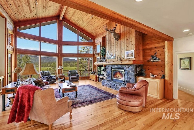 2510 Price Valley Rd, New Meadows, ID 83654 - living area featuring high vaulted ceiling, a fireplace, wood walls, light wood-type flooring, and recessed lighting