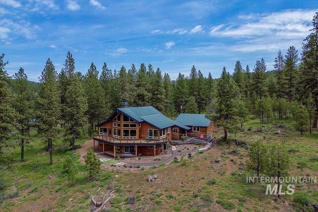2510 Price Valley Rd, New Meadows, ID 83654 - back of house featuring a deck and a wooded view
