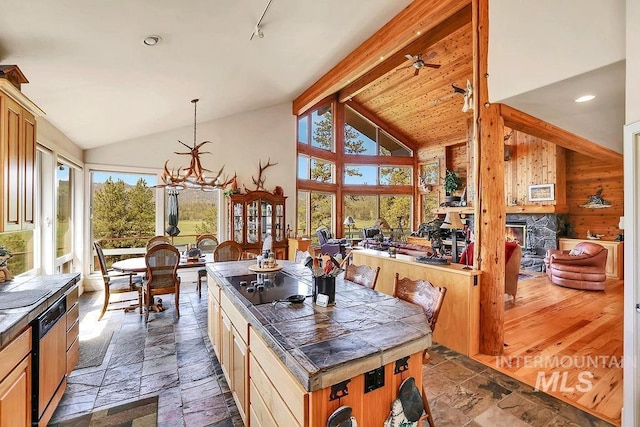 2510 Price Valley Rd, New Meadows, ID 83654 - kitchen with stone tile floors, black electric cooktop, beamed ceiling, a chandelier, and high vaulted ceiling