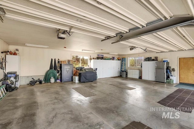 2510 Price Valley Rd, New Meadows, ID 83654 - garage with freestanding refrigerator and a garage door opener