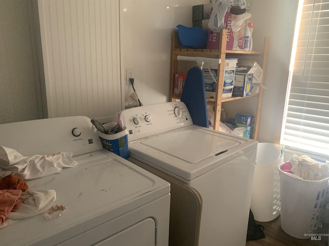 clothes washing area featuring washer and clothes dryer