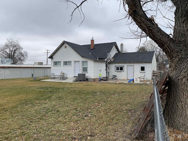 back of property with a yard, a patio, and central air condition unit