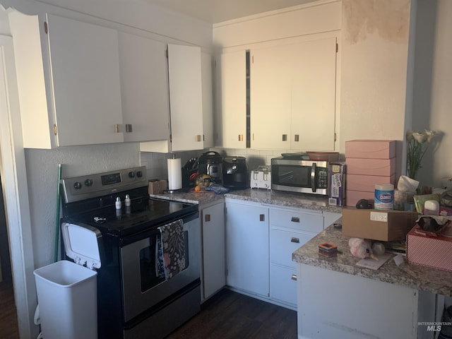 kitchen featuring backsplash, appliances with stainless steel finishes, dark hardwood / wood-style floors, and white cabinets