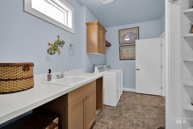 laundry room featuring sink, cabinets, and separate washer and dryer