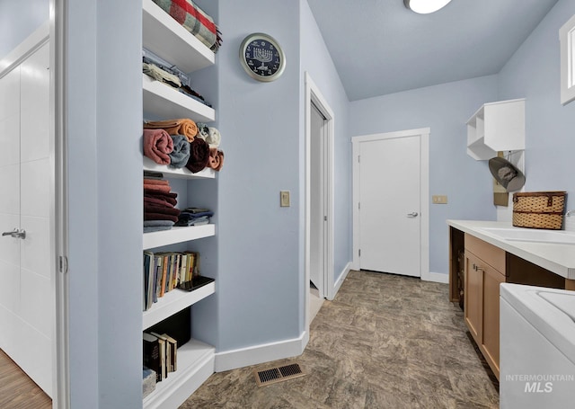 interior space with washer / dryer, cabinets, and sink