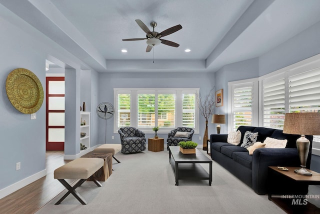 living room featuring ceiling fan and wood-type flooring