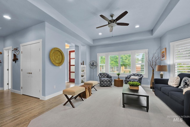 living room with ceiling fan and light hardwood / wood-style floors