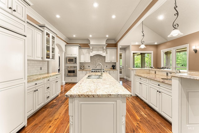 1137 N Cobblestone Way, Eagle, ID 83616 - kitchen with built in appliances, a spacious island, dark wood finished floors, a sink, and recessed lighting