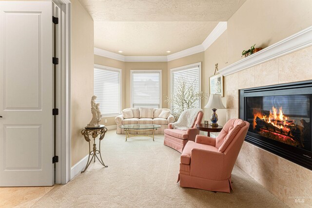 1137 N Cobblestone Way, Eagle, ID 83616 - living room featuring a fireplace, a textured ceiling, ornamental molding, carpet floors, and baseboards