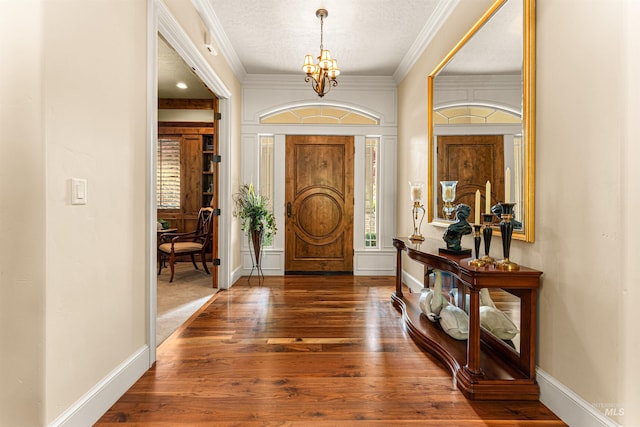 1137 N Cobblestone Way, Eagle, ID 83616 - entrance foyer with a chandelier, wood finished floors, baseboards, a textured ceiling, and crown molding