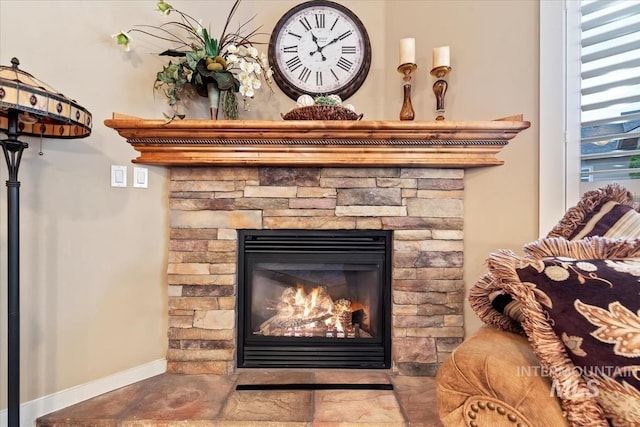 details featuring baseboards and a fireplace